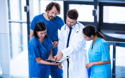 group of medical staff looking at the book