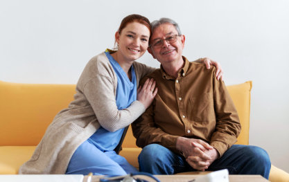 nurse and elderly man looking at the camera