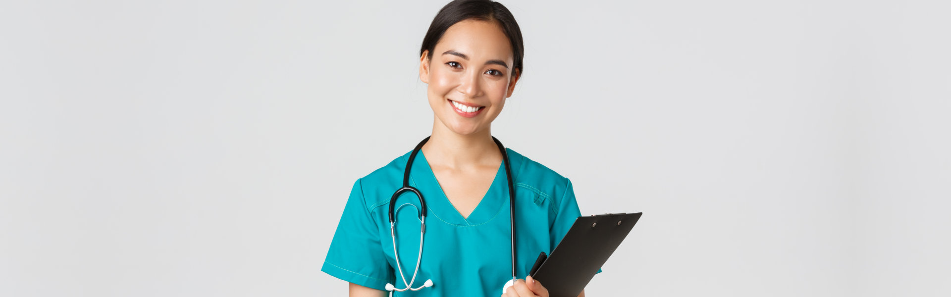 nurse holding folder and looking at the camera